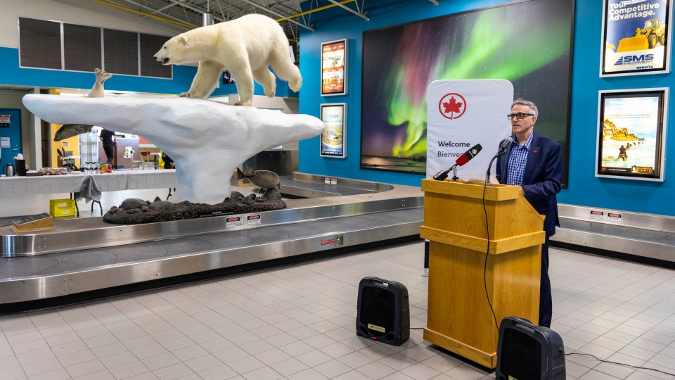Air Canada's Serge Corbeil announces a new Yellowknife-Toronto route at a Yellowknife Airport baggage carousel