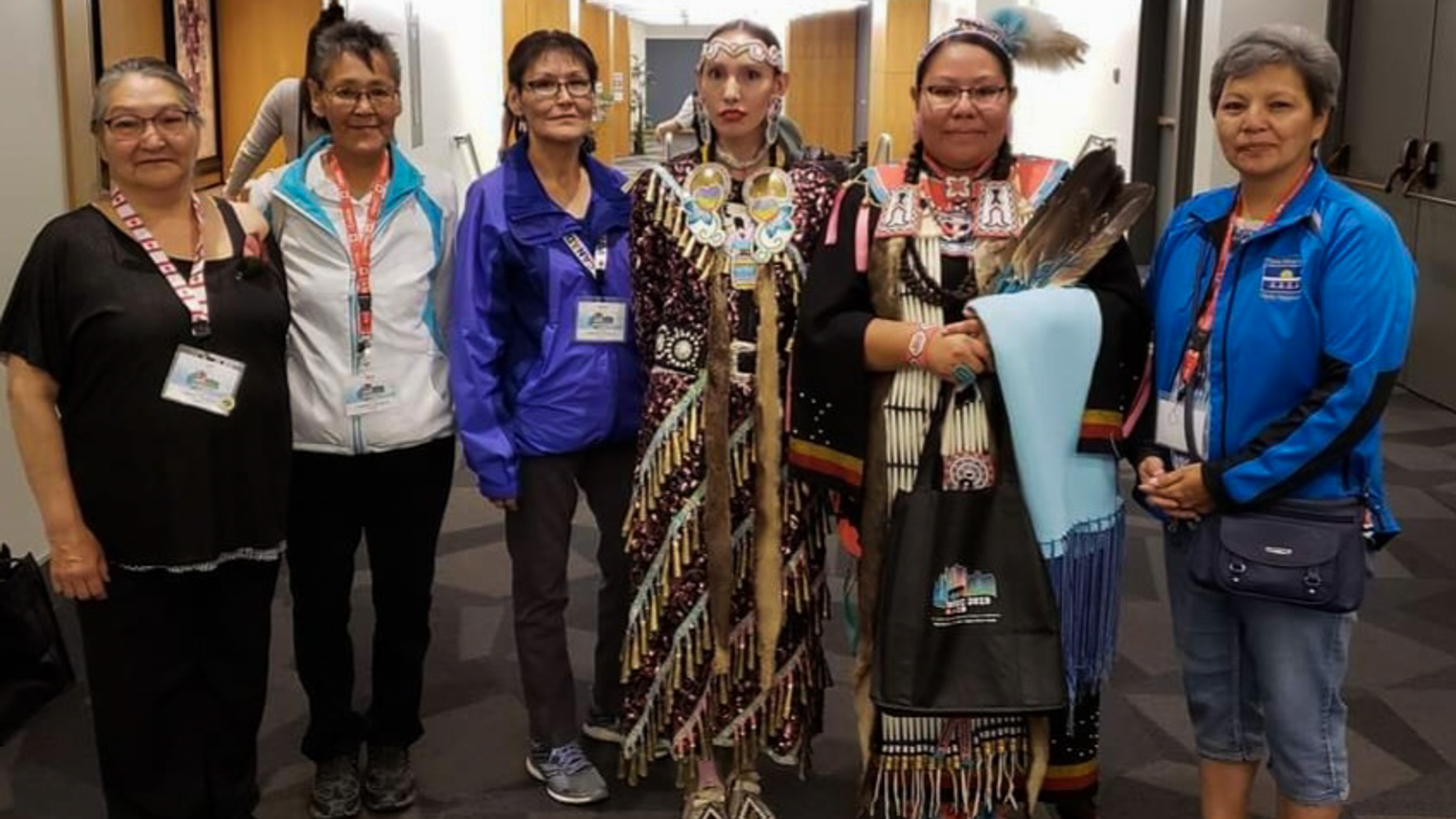 Agnes Pascal, third from left, appears in a supplied image alongside two dancers and people whose stories will appear in the Book of Hope.