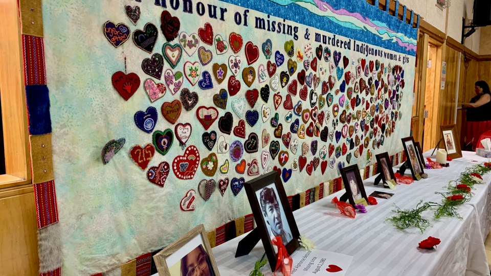 A tapestry hanging in Ndilǫ honours Indigenous people who are missing or were murdered