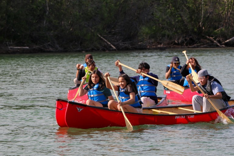 Youth participants compete in canoe races at the YKDFN National Indigenous People's Day celebration. Megan Miskiman/Cabin Radio