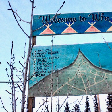 A sign welcomes travellers to Whatì