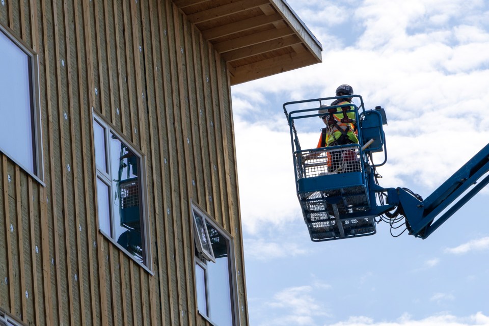 A June 2023 photo shows workers at the site of YWCA NWT's new transitional housing facility on Yellowknife's 54 Street. Ollie Williams/Cabin Radio