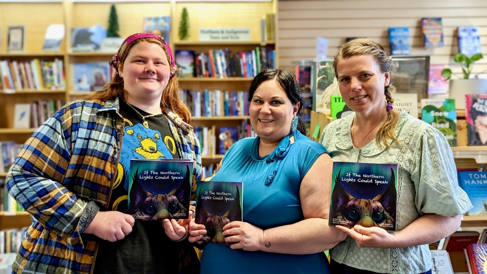 Kaylem Loomis, Myranda Bolstad and Sarah Kalnay-Watson with their new book. Ollie Williams/Cabin Radio