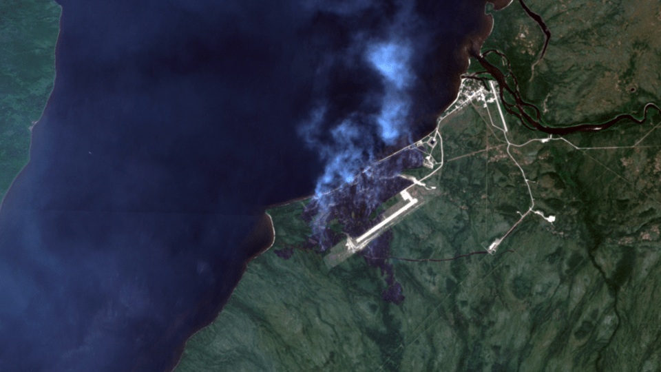 Sambaa K'e on Monday, seen from a Sentinel-2 satellite. An intentionally set fire that got out of control and consumed one home is seen burning near the airstrip. The main wildfire threatening the community remains some 10 kilometres away to the south.