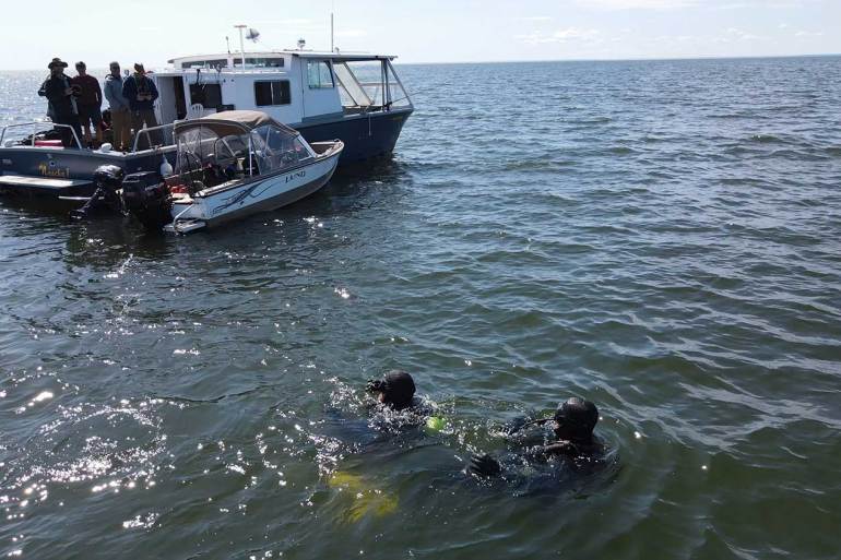 Divers Jeremy MacDonald and Collin Stockwell search in Great Slave Lake for a long-lost aircraft. Photo: Jeremy MacDonald