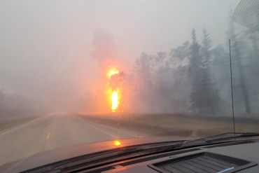 The highway between Enterprise and Louise Falls around 4am on Monday, August 14, 2023. The fire was still burning on both sides of the road. Photo: A G Carroll