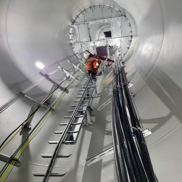 A worker fastens cables in the tower in June 2023. Photo: NTPC