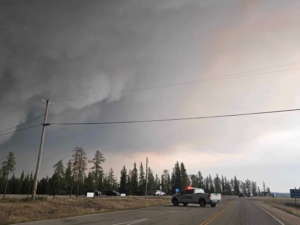 The Hay River-Enterprise junction on Sunday, August 13 with smoke from fire SS052 billowing on the left-hand side of the image near Hay River. April Broekaert-Glaicar/Photo