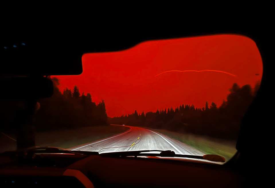 A stretch of highway between Enterprise and the NWT-Alberta border glows bright red sky the evening of Augus 13, 2023. Photo: Jorja Mulder