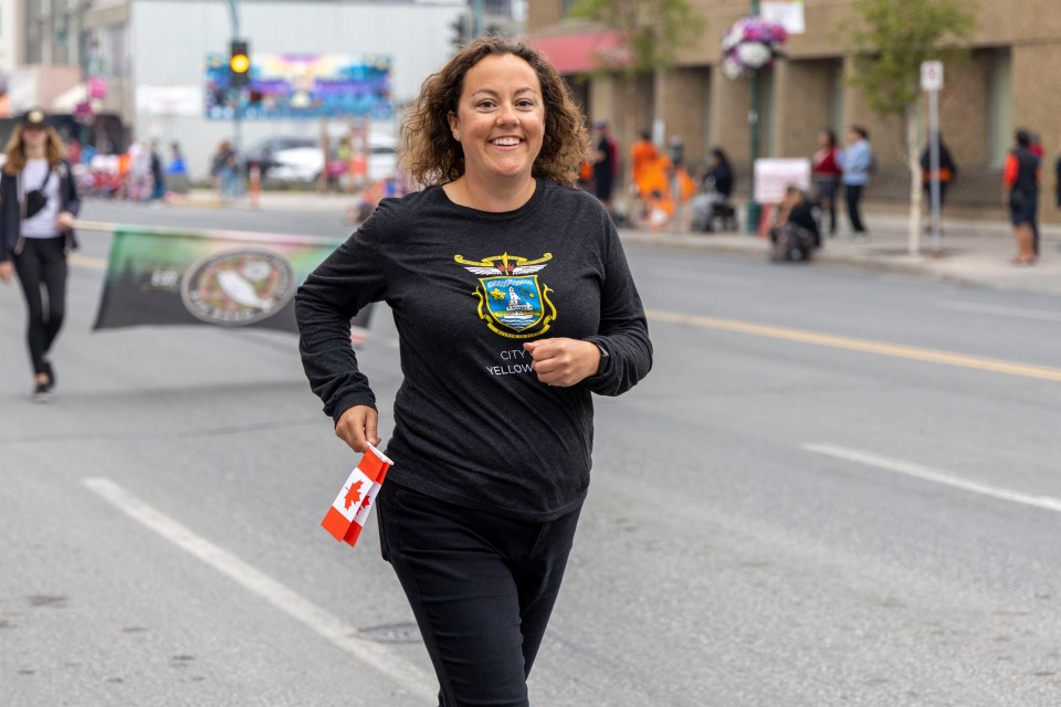 Rebecca Alty jogs to catch up with the parade.