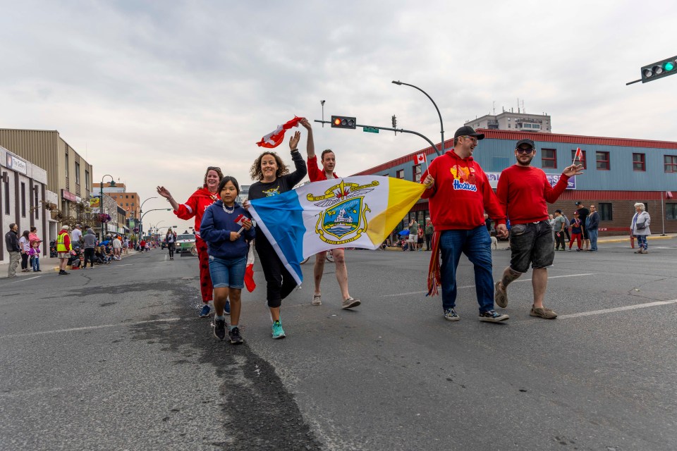 Mayor Rebecca Alty, third from left, with the city's flag near the front of the parade.
