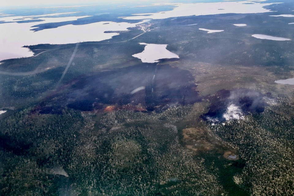 The burn area from a wildfire on the edge of Wekweètì is seen in an aerial photo published by the GNWT.
