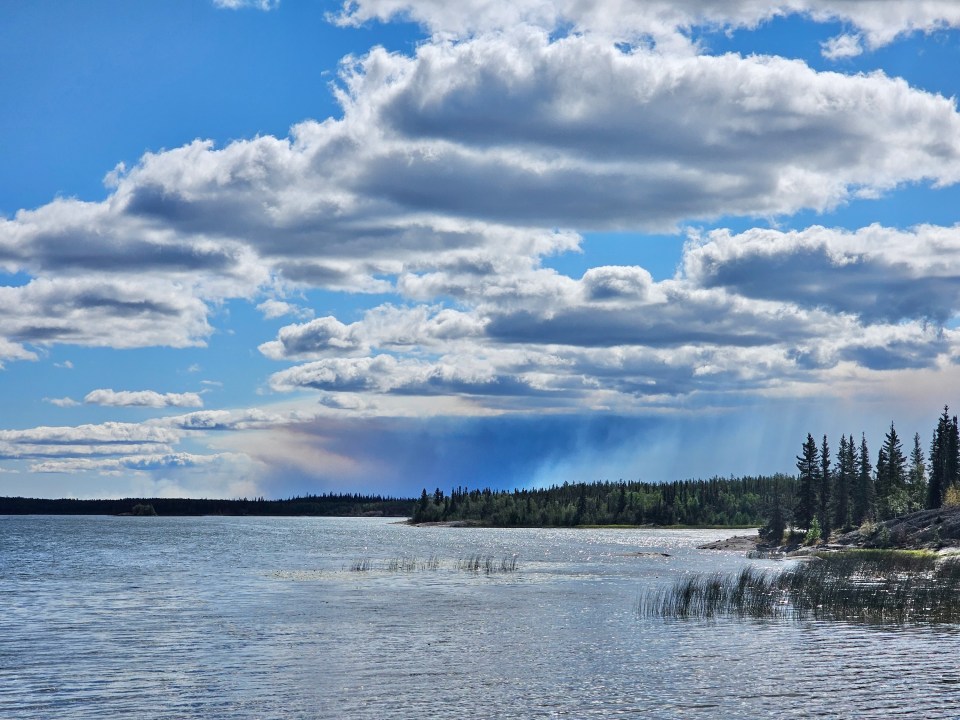 Fire ZF085's plume is seen from Hay Lake, east of Yellowknife. Ollie Williams/Cabin Radio