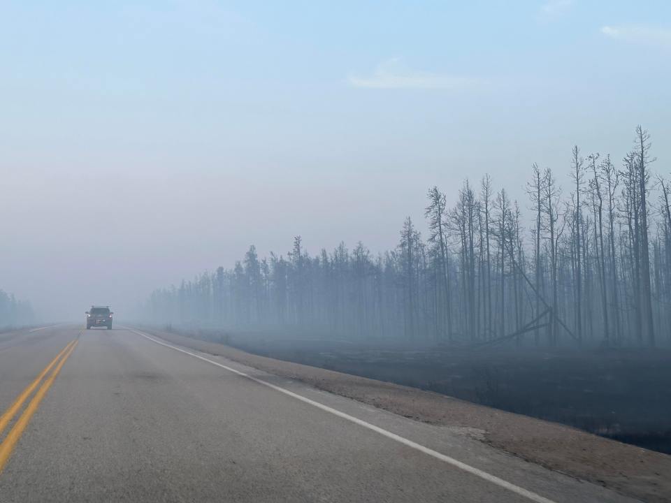 Smoke along an NWT highway on August 16, 2023. Megan Miskiman/Cabin Radio