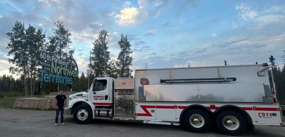 Firefighter Mic MacDonald alongside the Mannville Tanker from Minburn County Fire Service. Photo: County of Vermilion River