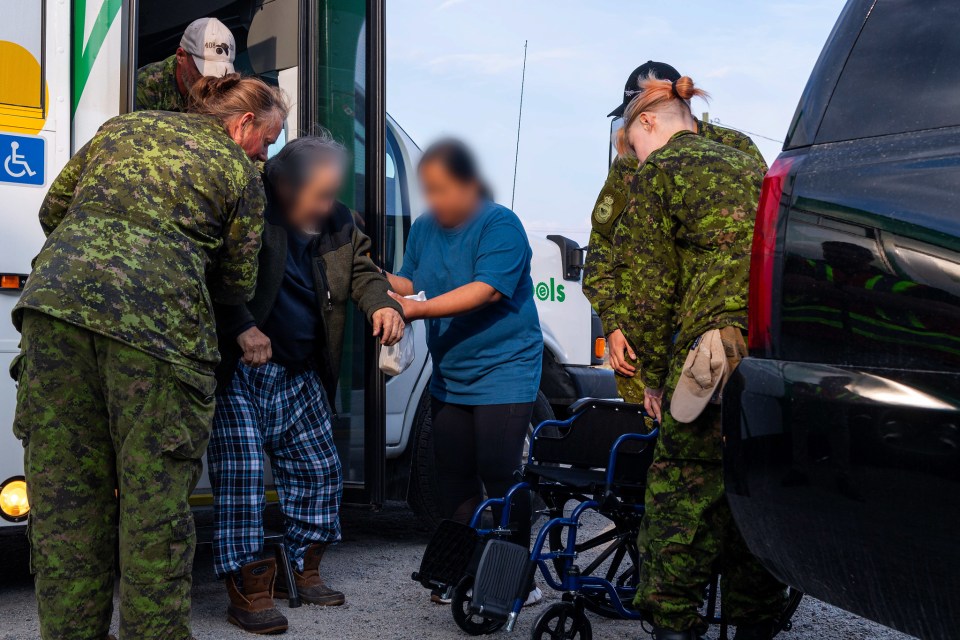 Members of 440 Transport Squadron help people with limited mobility. Photo: Sailor 1st Class Patrice Harvey, Canadian Armed Forces