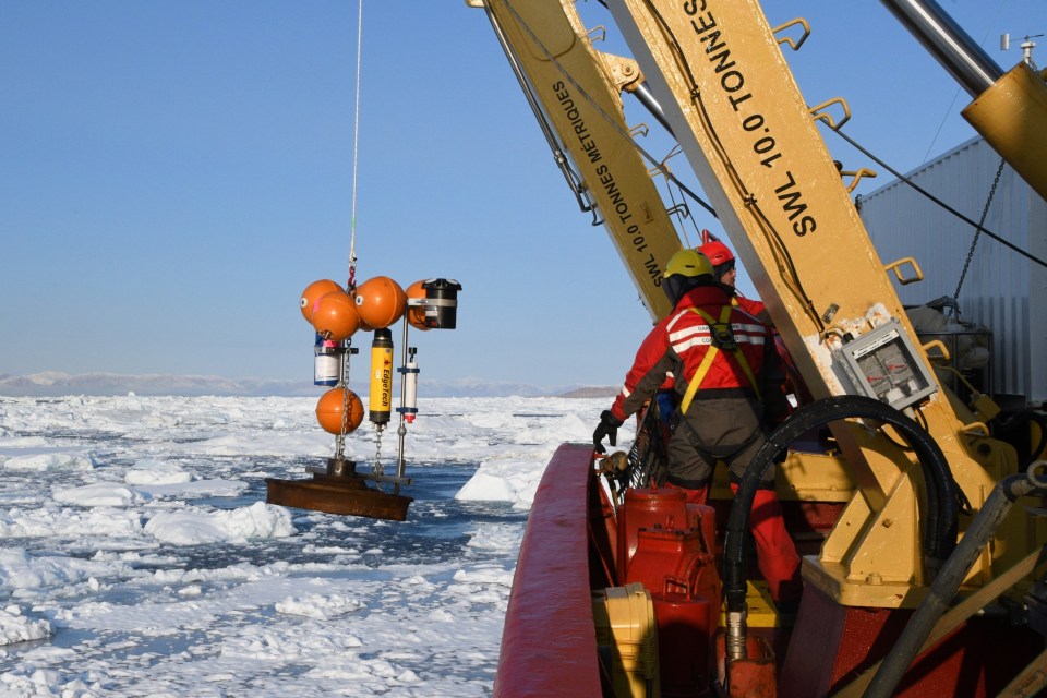 Crews deploy a mooring that will continue gather information after the researchers leave. Photo: Amundsen Science