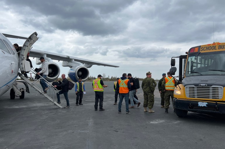 Evacuees board a Summit Air flight to Calgary on August 18, 2023. Photo: Trung Bui