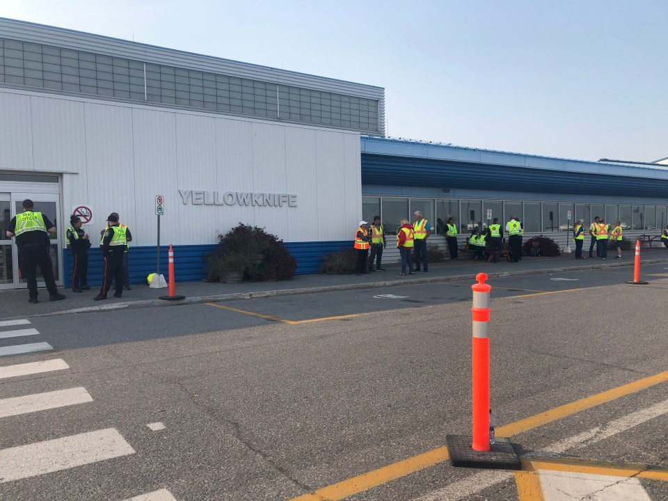 Staff and volunteers wait to help returning evacuees at Yellowknife Airport. Emily Blake/Cabin Radio