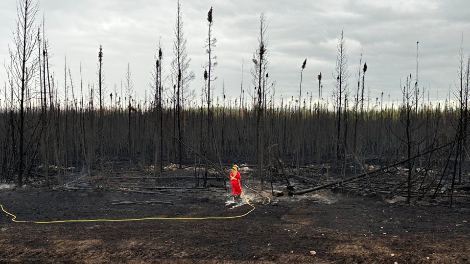 A firefighter attends to hot spots. Photo: Town of Hay River