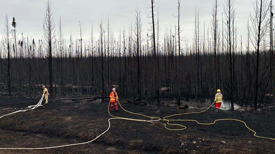 Firefighters attend to hot spots. Photo: Town of Hay River