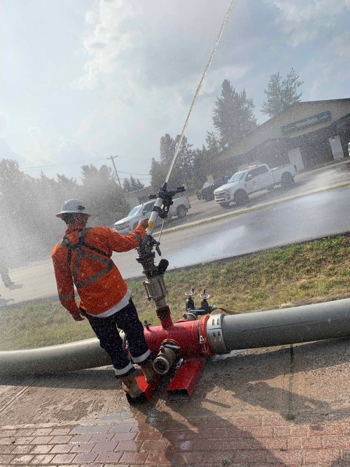 Water cannons are set up in Fort Smith to protect essential buildings throughout the town. The cannons can shoot a 200-foot radius, we’re told by firefighters on the ground. Photo: Paul Bannister