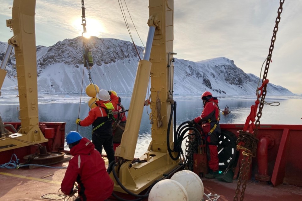 A mooring being deployed in Archer Fjord, which will collect information and particles over the course of a year. Audrey Limoges/University of New Brunswick