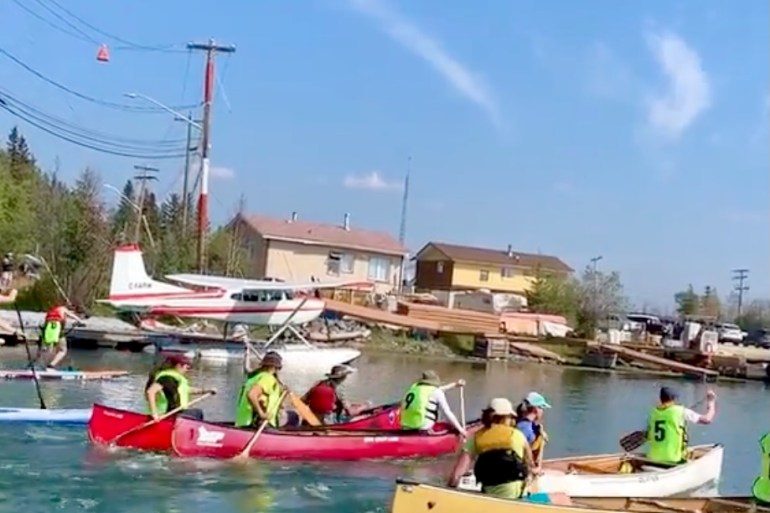 A canoe race at the 2023 Old Town Ramble and Ride. Megan Miskiman/Cabin Radio