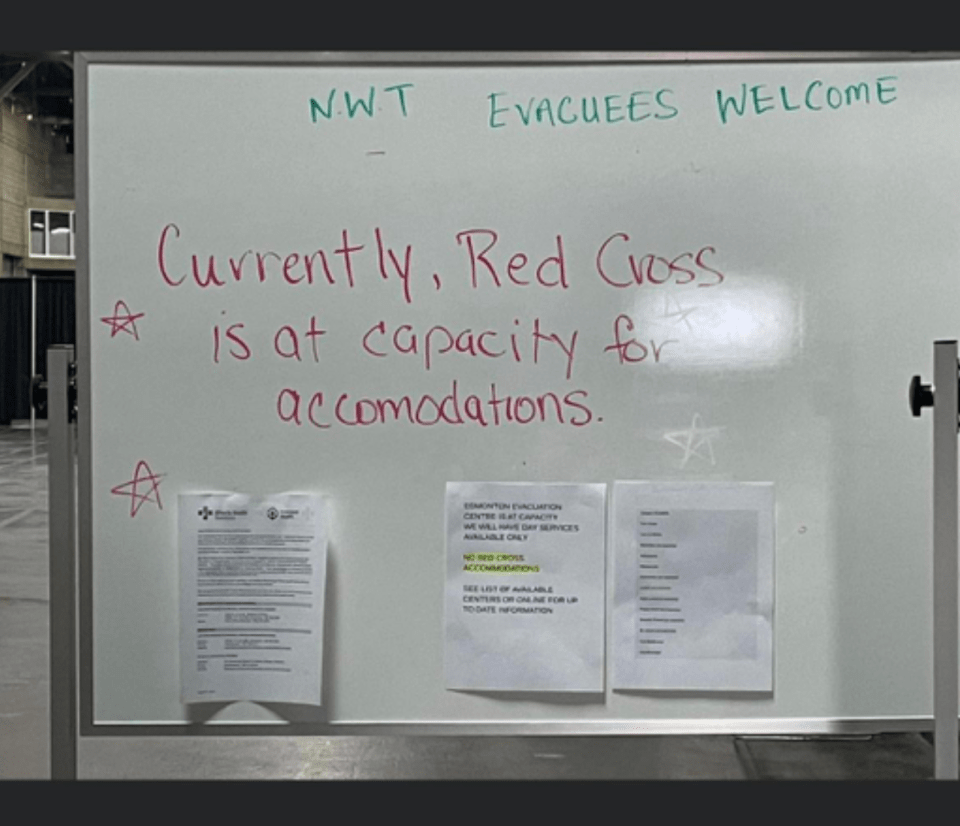 A whiteboard at an evacuation centre states the Red Cross accommodation is at capacity. Photo: Submitted