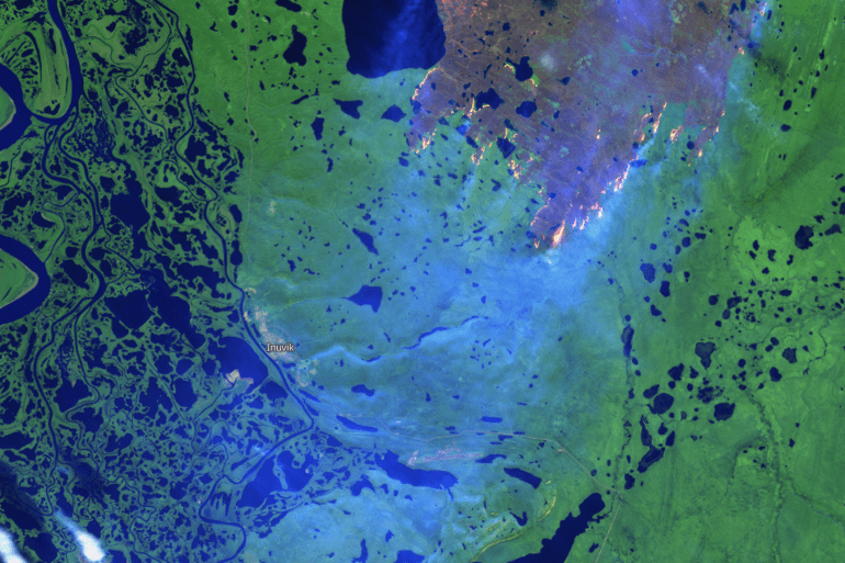 A Sentinel-2 false-colour satellite image shows EV014's burn area and hot-spots outside Inuvik on August 10, 2023.