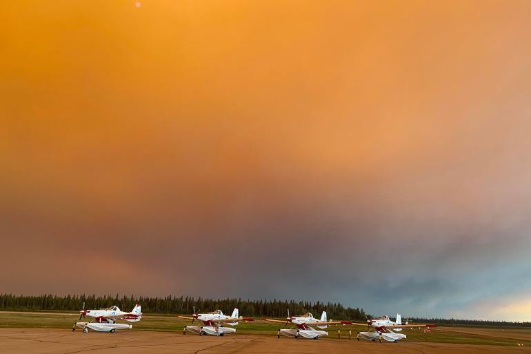 An orange sky behind Hay River's airfield on August 13, 2023. Photo: Céline Dixon