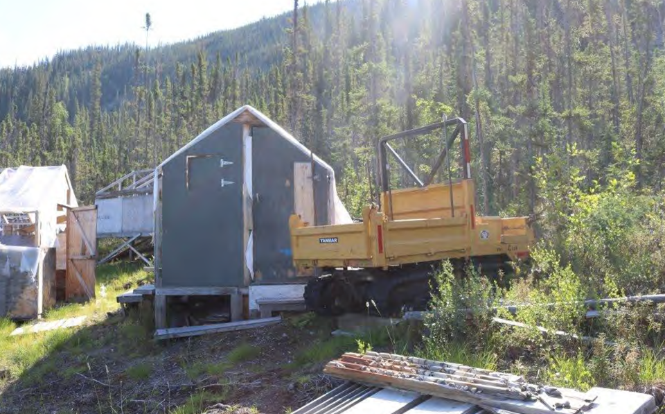 A tracked ATV and buildings at the site. Photo: GNWT