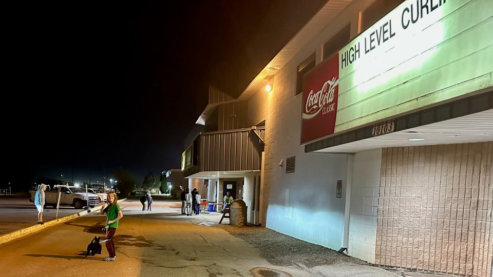 Evacuees gather outside High Level's evacuation centre on the night of September 8, 2023. Photo: Helen Barrieau