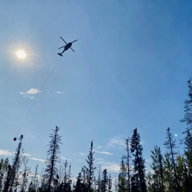 A helicopter bucketing a wildfire near Hay River on September 2, 2023. Mike Westwick/GNWT