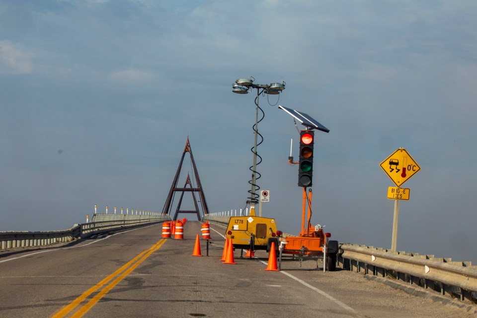 Travellers are stopped on the Deh Cho Bridge to observe one-lane traffic rules. The restrictions came into effect on August 8, when one of the bridge's 24 massive cables failed, and were still in effect more than a month later. Photo: Bill Braden