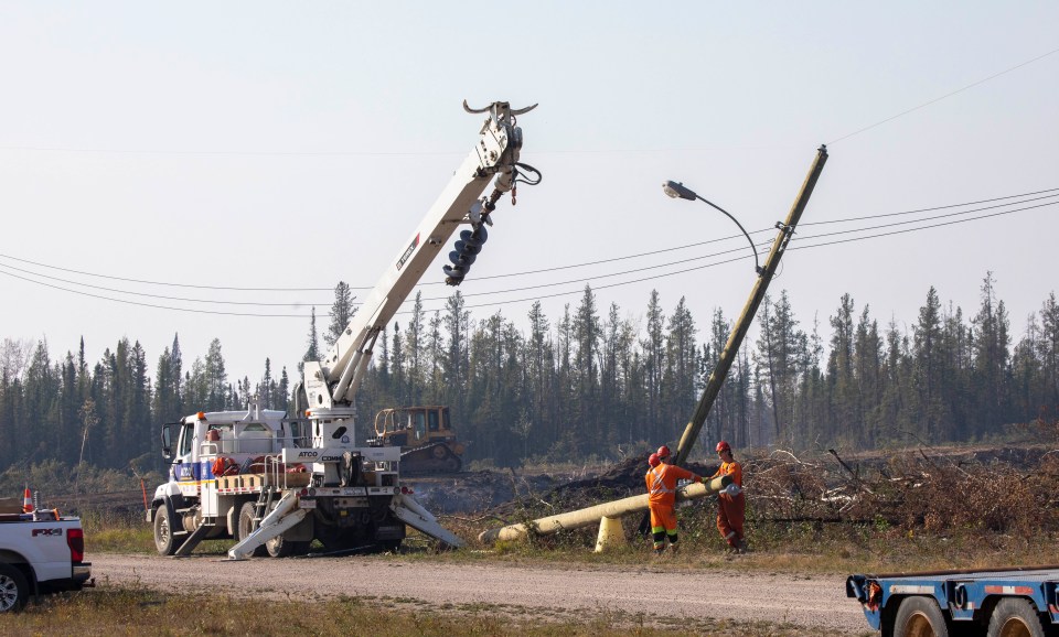 Atco Utilities line crews replace burnt power poles around the community of Enterprise. Photo: Bill Braden