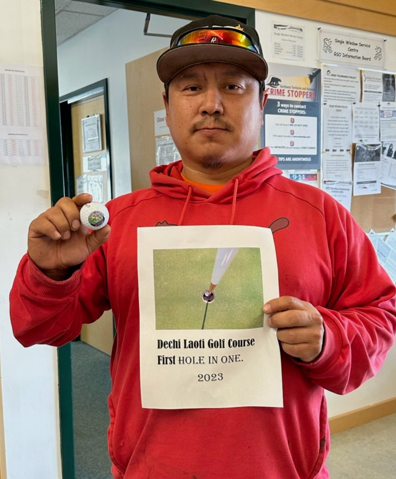 Robert Judas celebrates his achievement with a certificate showing a photo of his ball in the hole. Photo: Submitted