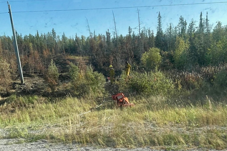 Fire crews at work beyond the checkpoint. Photo: Candace Meadus