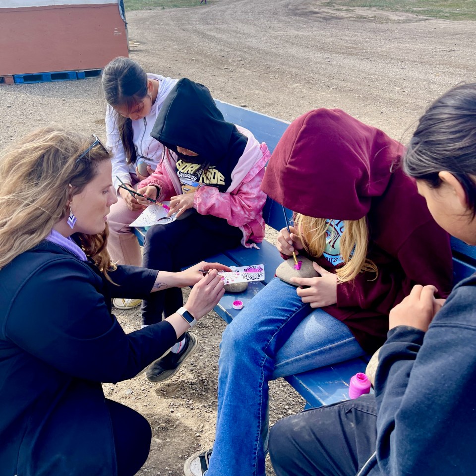 Tuktoyaktuk students paint rocks during a school barbecue and picnic at the end of the school year. Photo: Supplied