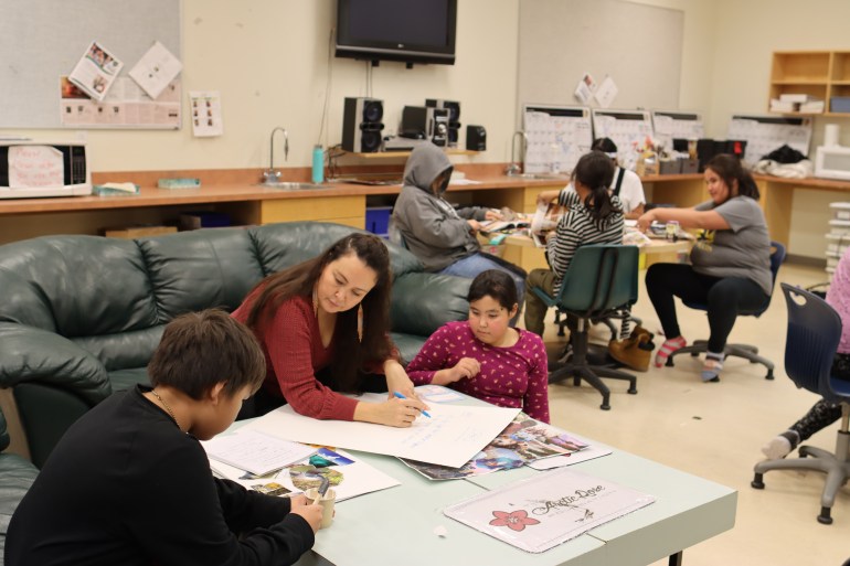 Leela Gilday works with students at Mildred Hall School's Messy Book Program. Aastha Sethi/Cabin Radio