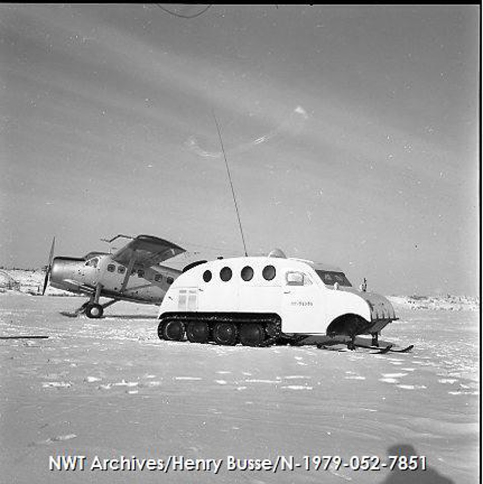 In February 1955, during the Operation Bulldog military exercise, a Bombardier snow machine spent time on Yellowknife's Back Bay alongside a Canadian military aircraft. NWT Archives/Henry Busse fonds/N-1979-052: 7851