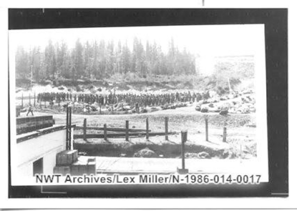 Lex Miller, who worked for the Mackenzie River Transport Company in the early 1940s, took this photo of US troops arriving to build the Canol Trail. He captioned this image in part: "Because of war restrictions we had no idea thousands of men would arrive suddenly. Many died from cold and insects and drownings. MRT Dock, Fort Smith, Summer 1942." NWT Archives/Lex Miller fonds/N-1986-014: 0017