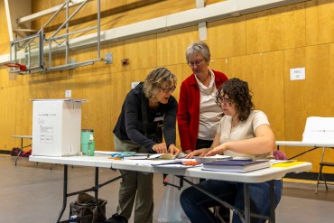 Polling station workers prepare Yellowknife's multiplex ahead of polls opening on the morning of November 14, 2023. Ollie Williams/Cabin Radio