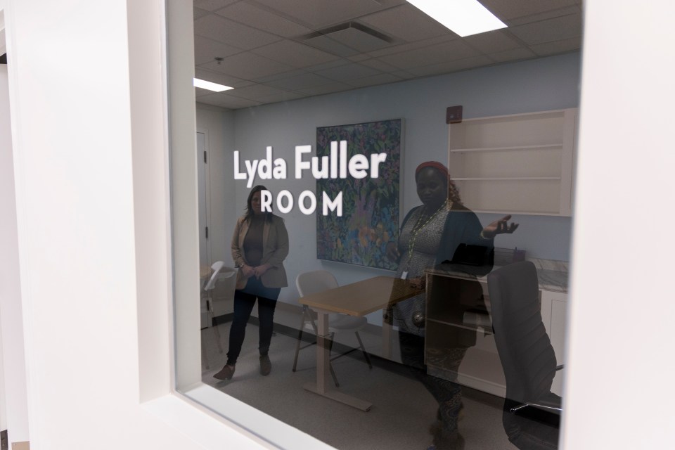 Alayna Ward, left, and Hawa Dumbuya-Sesay are reflected in the window of the Lyda Fuller Room. Ollie Williams/Cabin Radio
