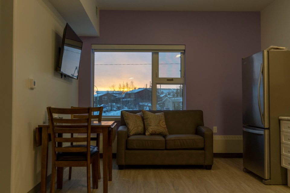 The sun sets behind one of the new building's units. Ollie Williams/Cabin Radio