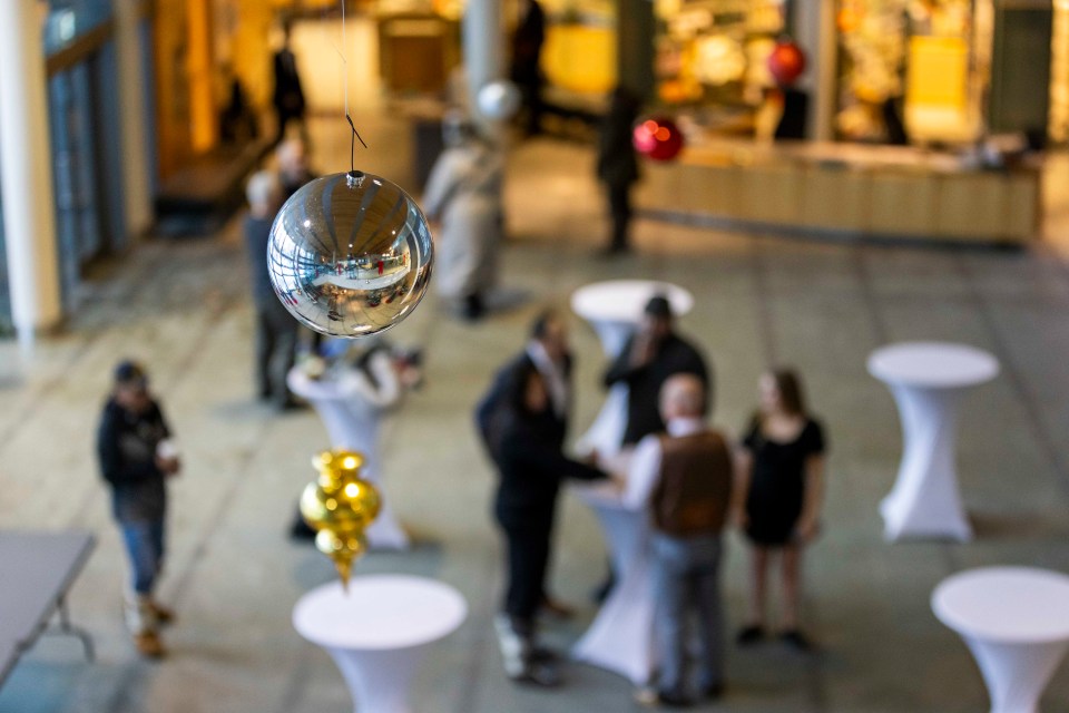 Christmas decorations hang above the Great Hall, where MLAs congregated after their ceremony. Ollie Williams/Cabin Radio
