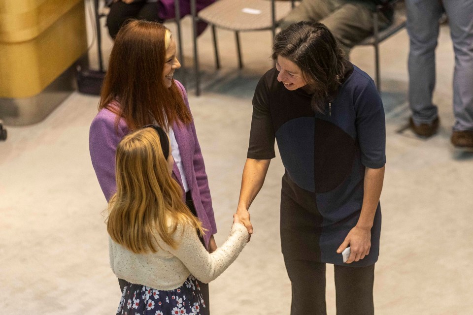 Shauna Morgan, right, greets a daughter of Caroline Wawzonek, left. Ollie Williams/Cabin Radio