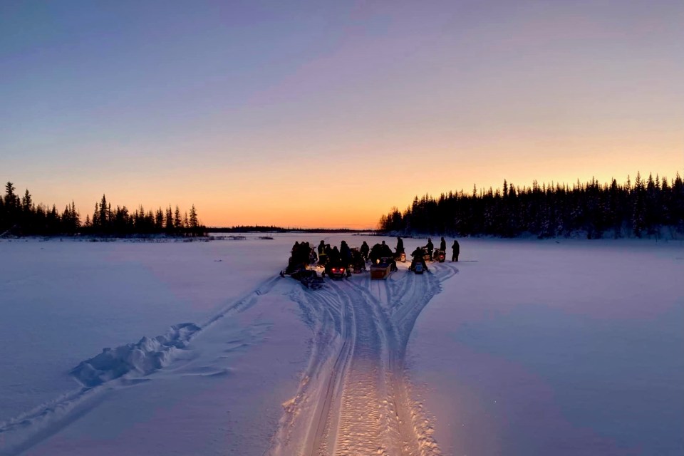 Snowmobiles gather on a trip from Whatì to Behchokǫ̀ in honour of the late Frank Gargan. Photo: Shaun Moosenose