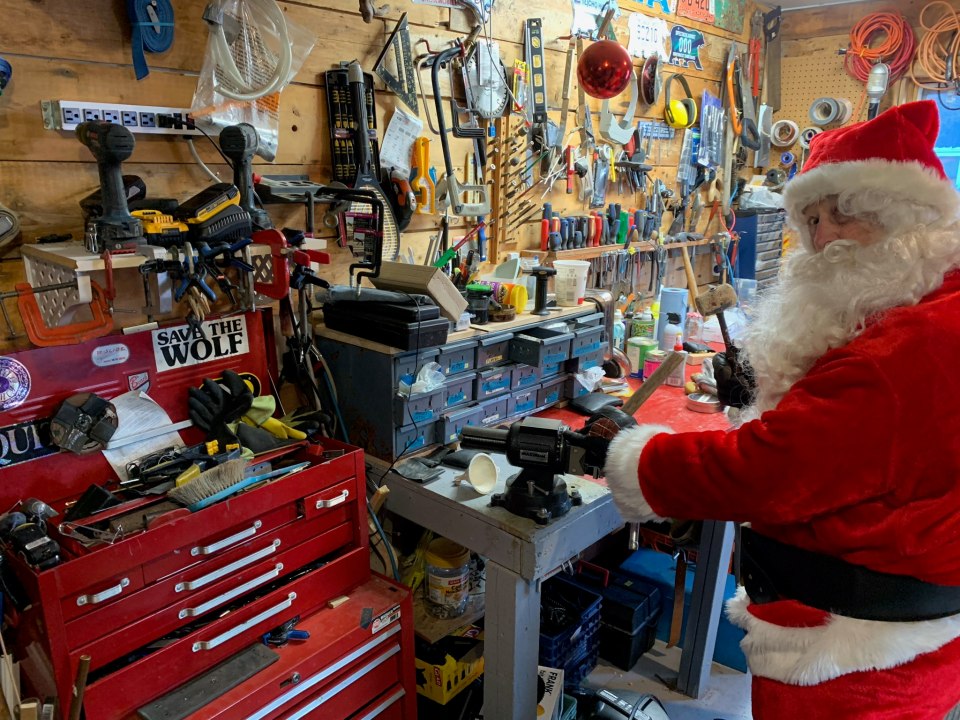 Last-minute adjustments in Santa's workshop before Saturday's ride. Photo: Submitted