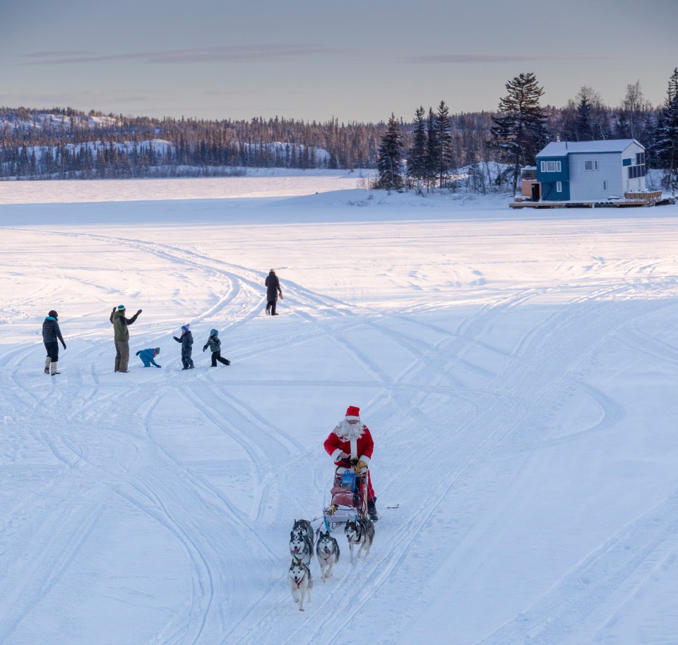 Santa passes some residents out on the ice. Photo: Bill Braden
